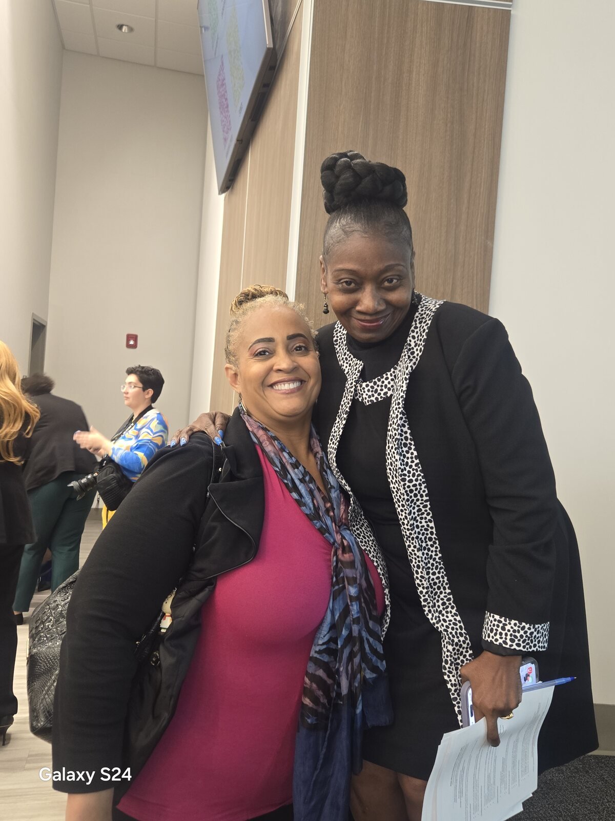 Gloria Joyner with a community leader at an indoor event